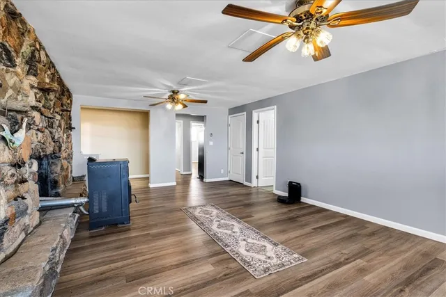 a living room with fireplace furniture and a wooden floor
