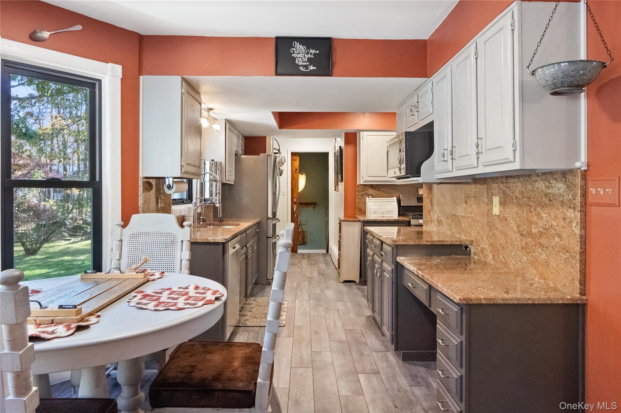 12 Chapel Road Newburgh, NY 12550 - Photo 12 of 46 a open kitchen with stainless steel appliances granite countertop a stove a sink dishwasher and cabinets with wooden floor