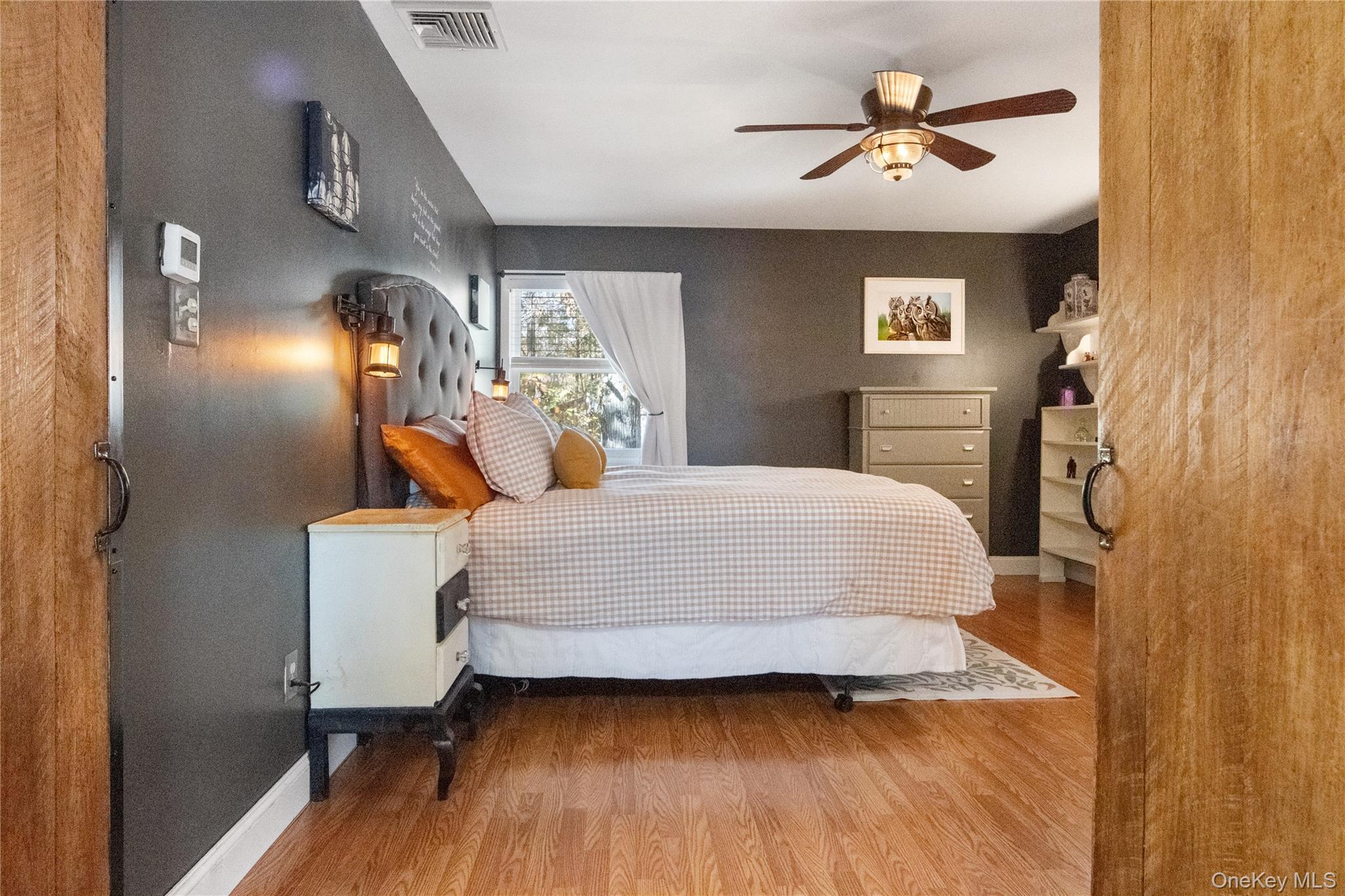 12 Chapel Road Newburgh, NY 12550 - Photo 20 of 46 a bedroom with a bed and a chandelier