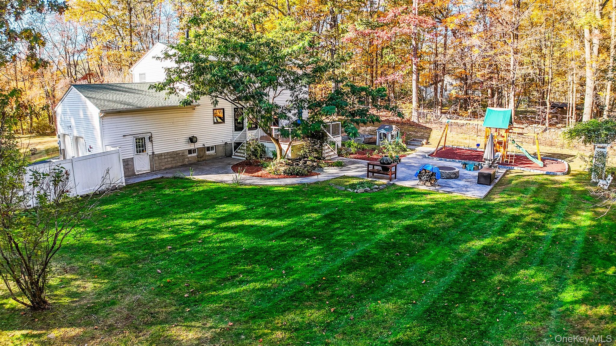 12 Chapel Road Newburgh, NY 12550 - Photo 32 of 46 a view of a backyard with table and chairs and a fire pit