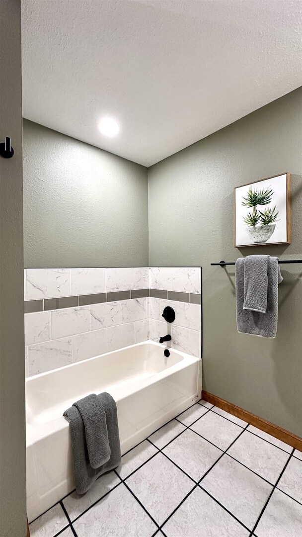 1111 East Elm Street West Frankfort, IL 62896 - Photo 19 of 27 a bathroom with a tub and mirror