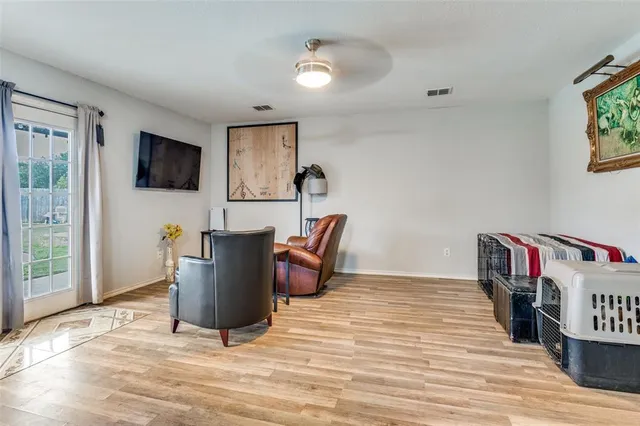 a living room with furniture and a wooden floor