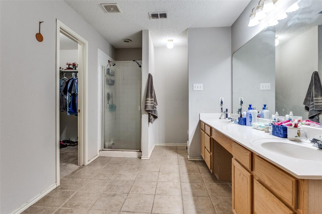4254 Birch Creek Road Fort Worth, TX 76244 - Photo 17 of 25 a bathroom with a sink a mirror and a shower