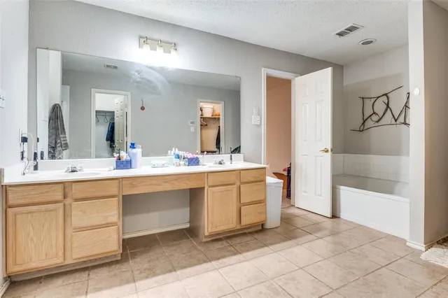 a bathroom with a sink a mirror and a shower