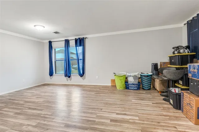 a view of a room with wooden floor and chair
