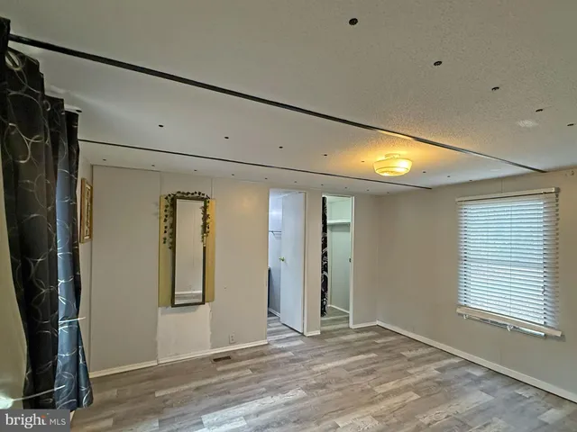 a view of a room with wooden floor and windows