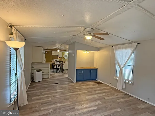 a view of a room with wooden floor and windows
