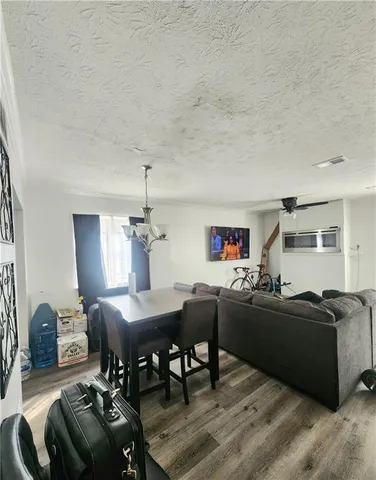 a living room with furniture and a dining table