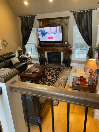 a room with furniture a flat screen tv and a fireplace