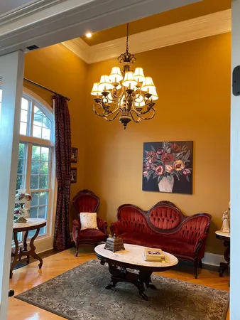a living room with furniture and a chandelier