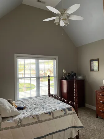 a bedroom with a bed and a television