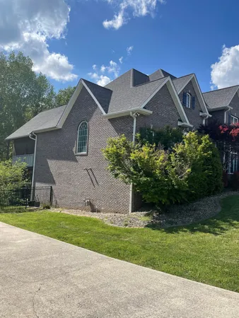 a front view of house with yard and green space