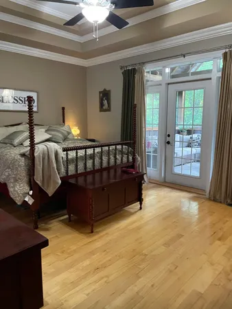 a bed sitting in a bedroom next to a window