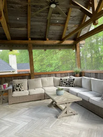 a living room with furniture and large windows