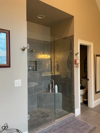 a bathroom with a glass shower door