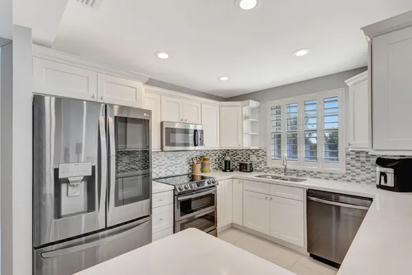 a kitchen with a refrigerator and a sink