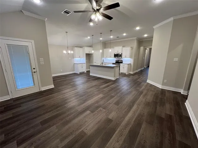 a view of kitchen and hall with wooden floor