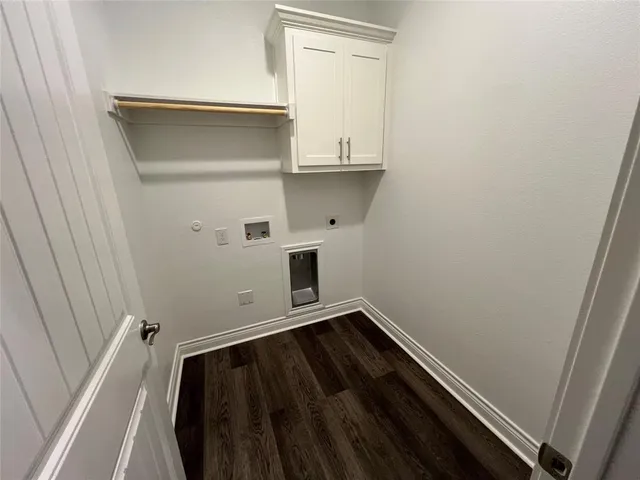 a view of storage and utility room with wooden floor