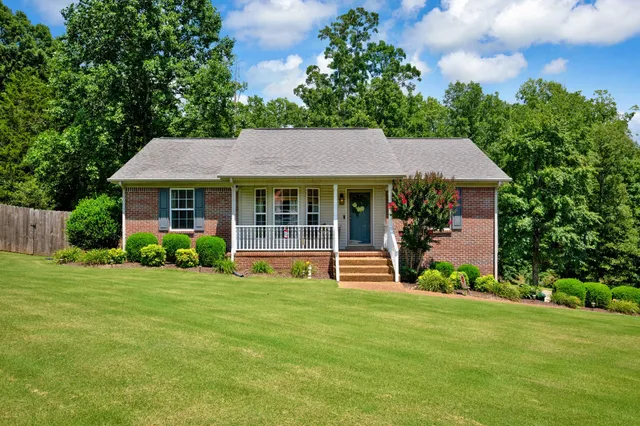 a front view of a house with garden and porch
