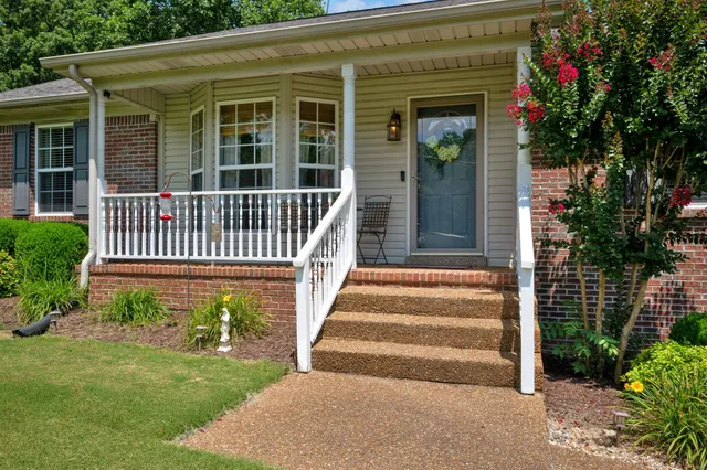 a living room with furniture a flat screen tv and a window
