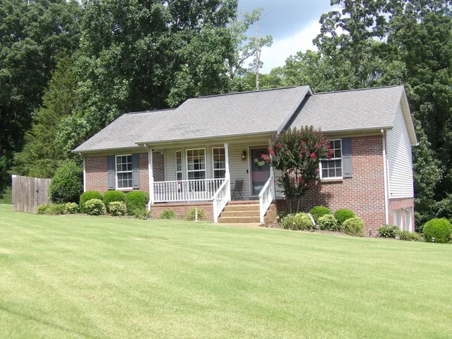 a front view of a house with a yard table and chairs