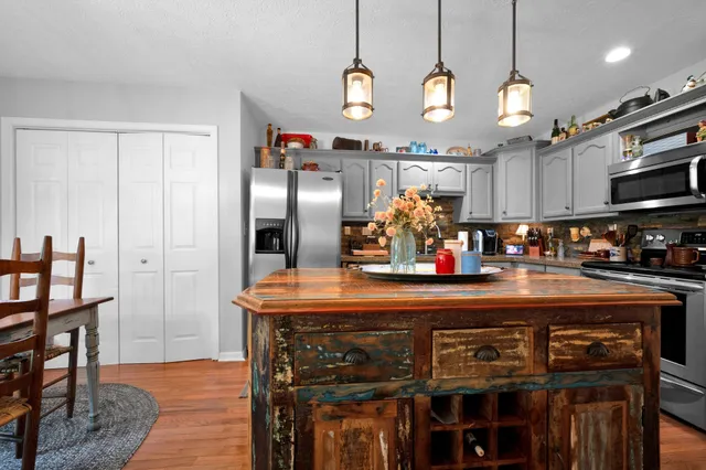 a dining room with furniture a chandelier and window