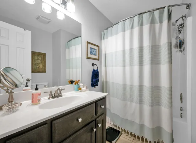 a bathroom with a sink a mirror and a shower