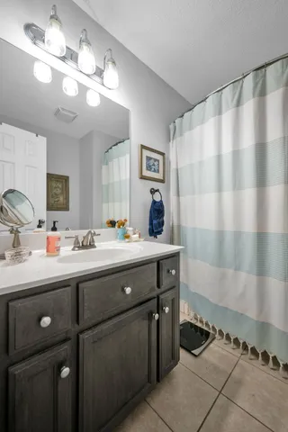 a bedroom with a bed and dresser with mirror