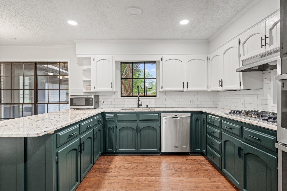 4101 Briar Cliff Road Temple, TX 76502 - Photo 11 of 40 a kitchen with stainless steel appliances granite countertop a stove and cabinets