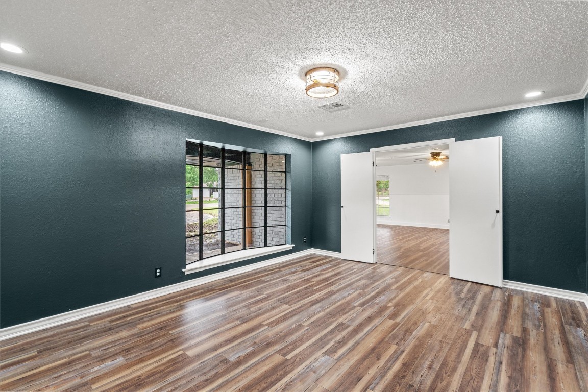 4101 Briar Cliff Road Temple, TX 76502 - Photo 17 of 40 a view of an empty room with wooden floor and a window