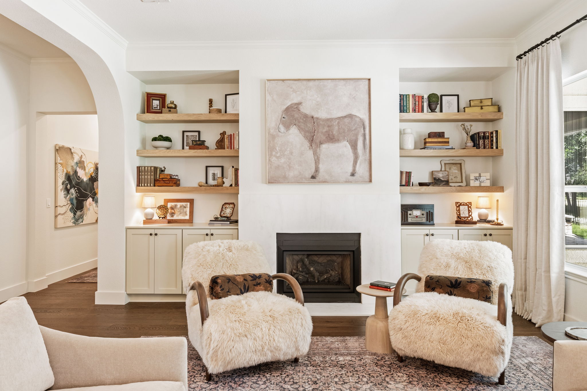 118 Cold Springs Drive Georgetown, TX 78633 - Photo 5 of 40 Custom built-in shelving flanks a cozy fireplace, creating a warm and inviting gathering space.