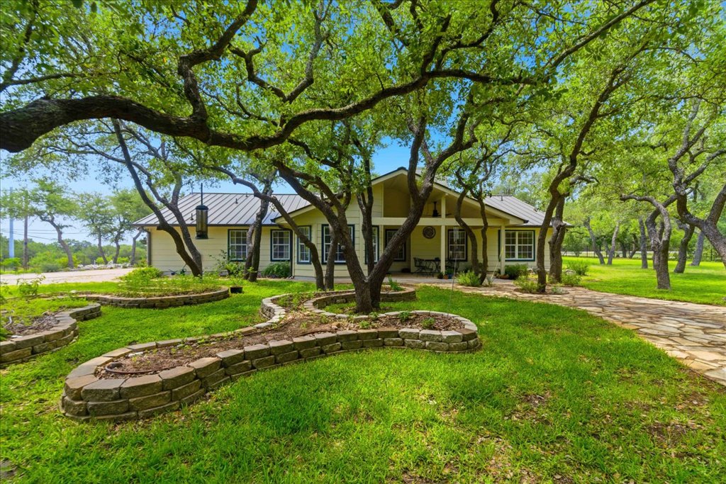 12702 Trails End Road Cedar Park, TX 78641 - Photo 28 of 40 Charming single-story home set beneath a canopy of mature trees, with thoughtfully designed landscaping and multiple outdoor living spaces.