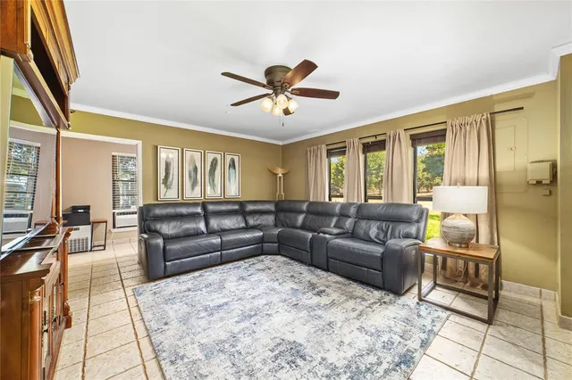a living room with furniture and a chandelier