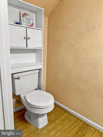 a white toilet sitting next to a shower