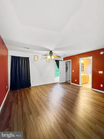 a view of a livingroom with wooden floor and stairs
