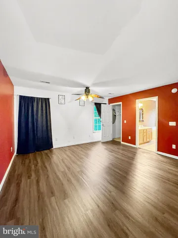 a view of a livingroom with wooden floor and stairs