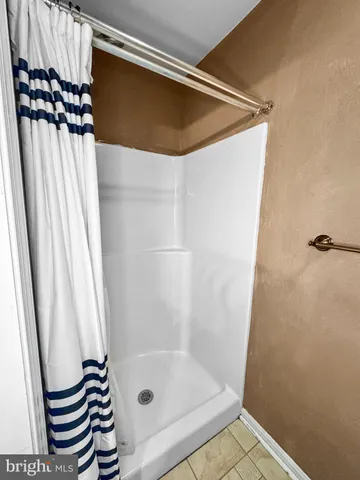 a bathroom with a shower and a sink