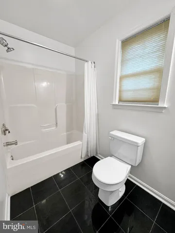 a bathroom with a toilet a sink and bathtub
