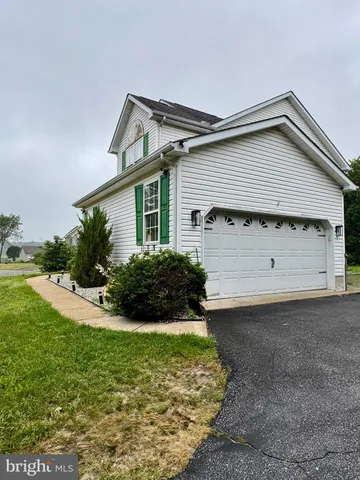 a view of a house with a yard and plants