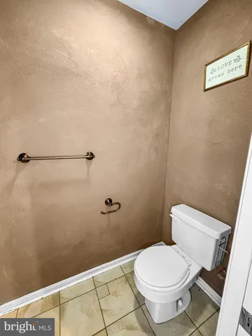 a white toilet sitting next to a shower