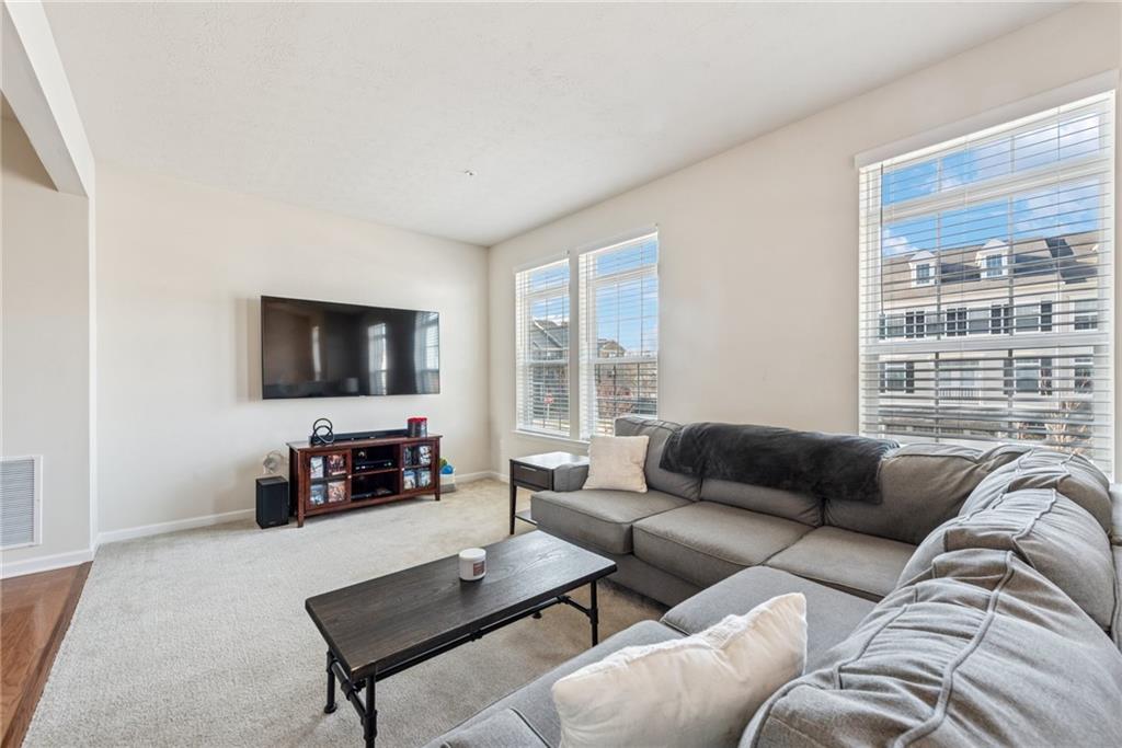 204 Eagle Drive Cranberry Township, PA 16066 - Photo 12 of 34 a living room with furniture and a flat screen tv