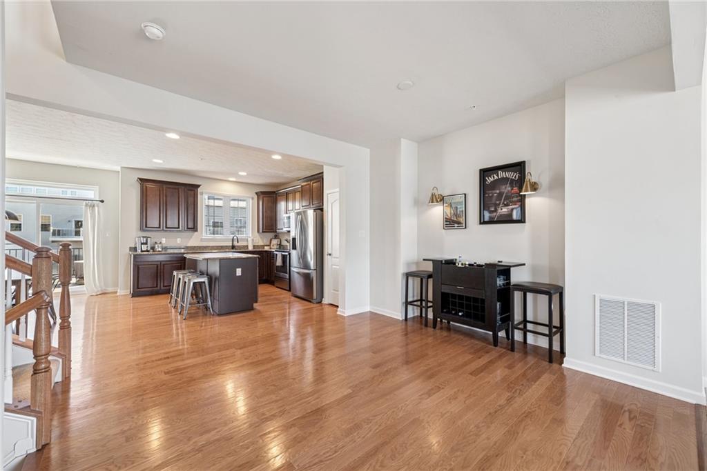 204 Eagle Drive Cranberry Township, PA 16066 - Photo 10 of 34 a living room with furniture wooden floor and kitchen view