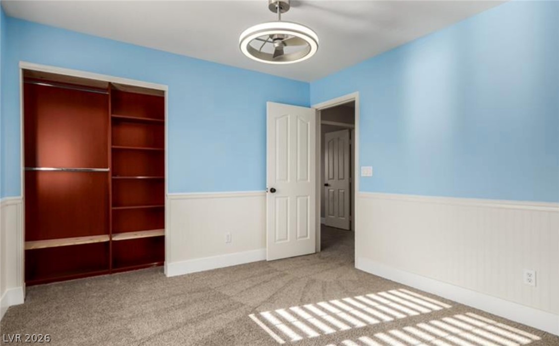 264 Pointe Ranier Avenue Henderson, NV 89012 - Photo 27 of 43 A vibrant room featuring wainscoting and built-in shelving provides practical storage and a cheerful atmosphere.