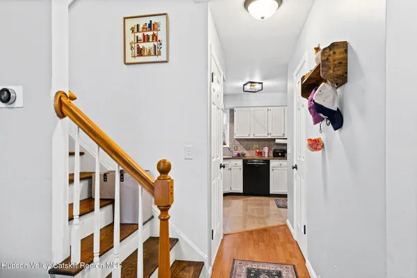 a hallway with front door wooden floor and windows