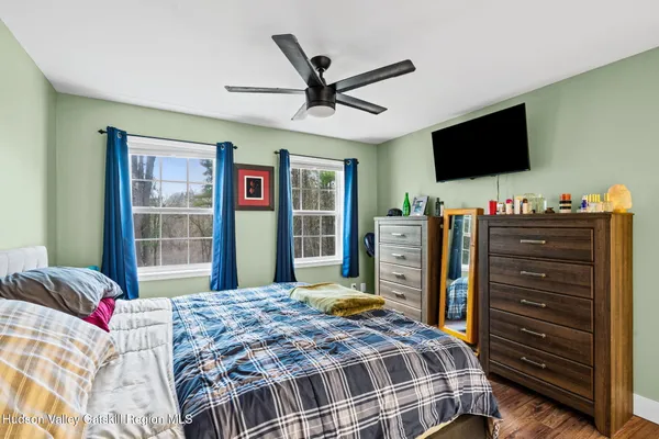a bedroom with a bed and a flat screen tv