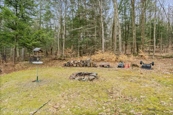 a view of swimming pool with a yard and trees