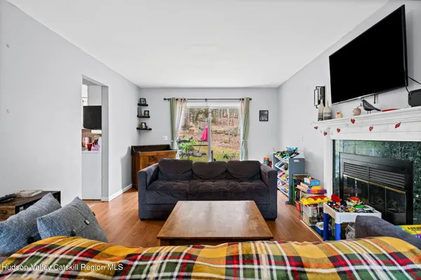 a bedroom with furniture and a flat screen tv