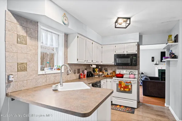 a kitchen with stainless steel appliances granite countertop a sink a stove and a refrigerator