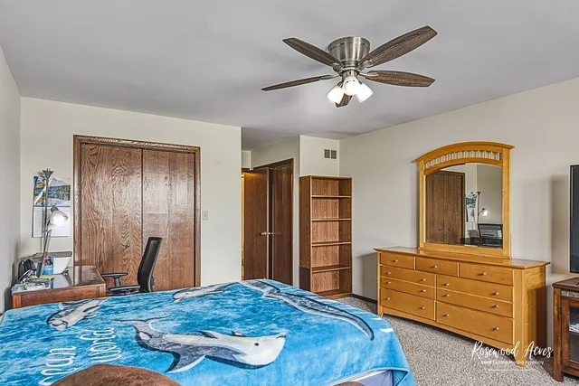 a bedroom with a bed and a dresser