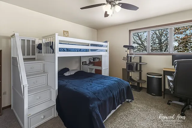 a bedroom with a bed and a desk